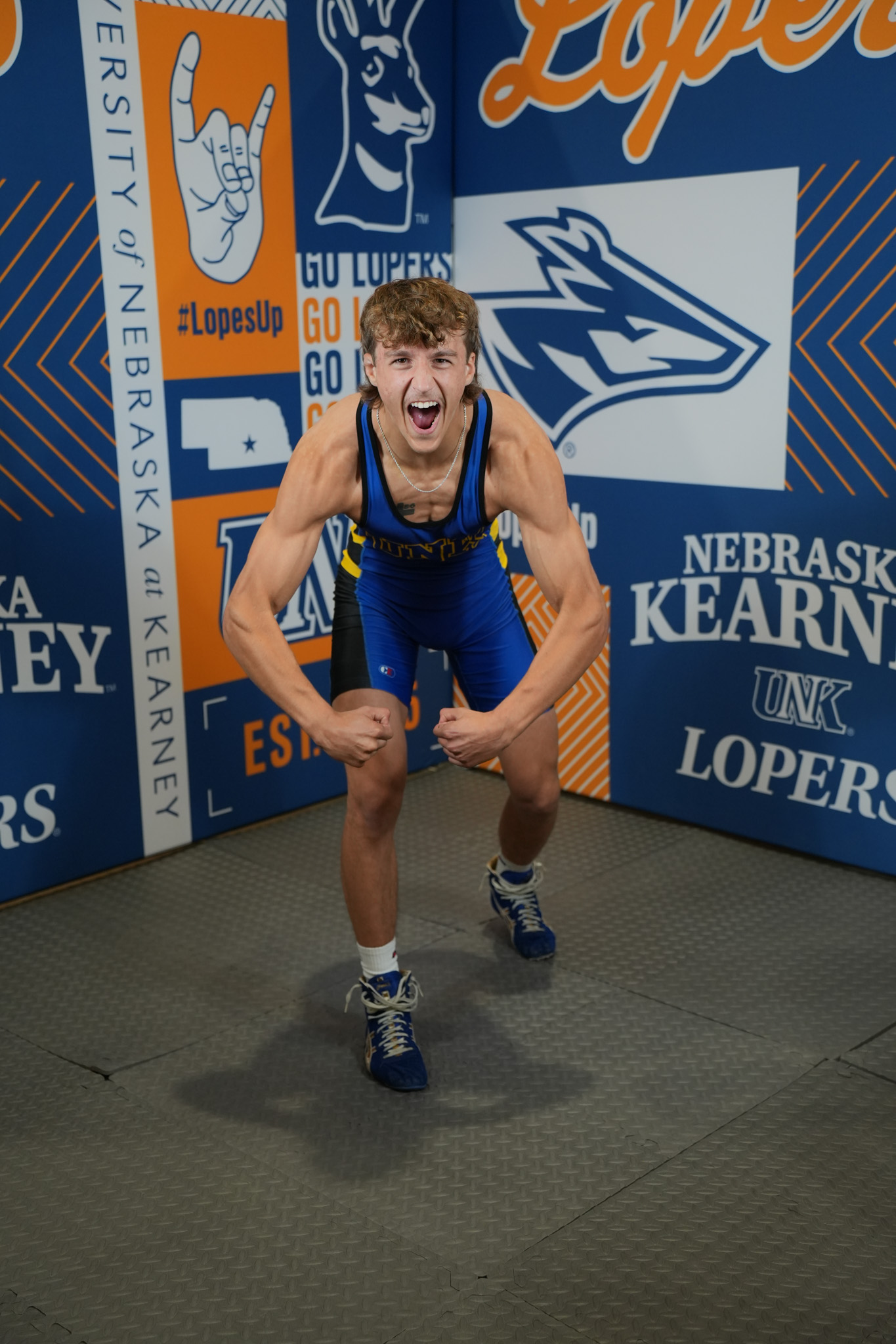 DSC05341 UNK wrestler Cael Robb yells and flexes for a photo.