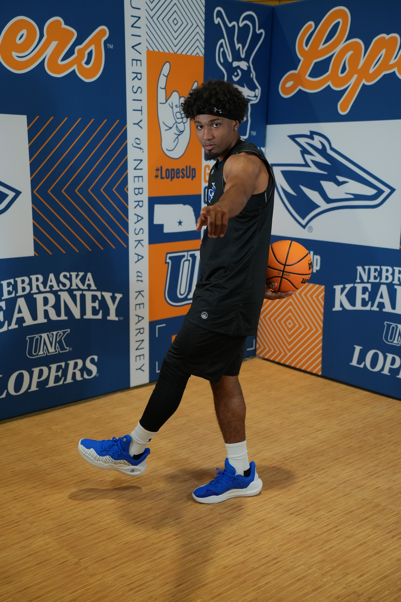 DSC05886 UNK Basketball player Trey Hepburn poses with the basketball and points to the camera.