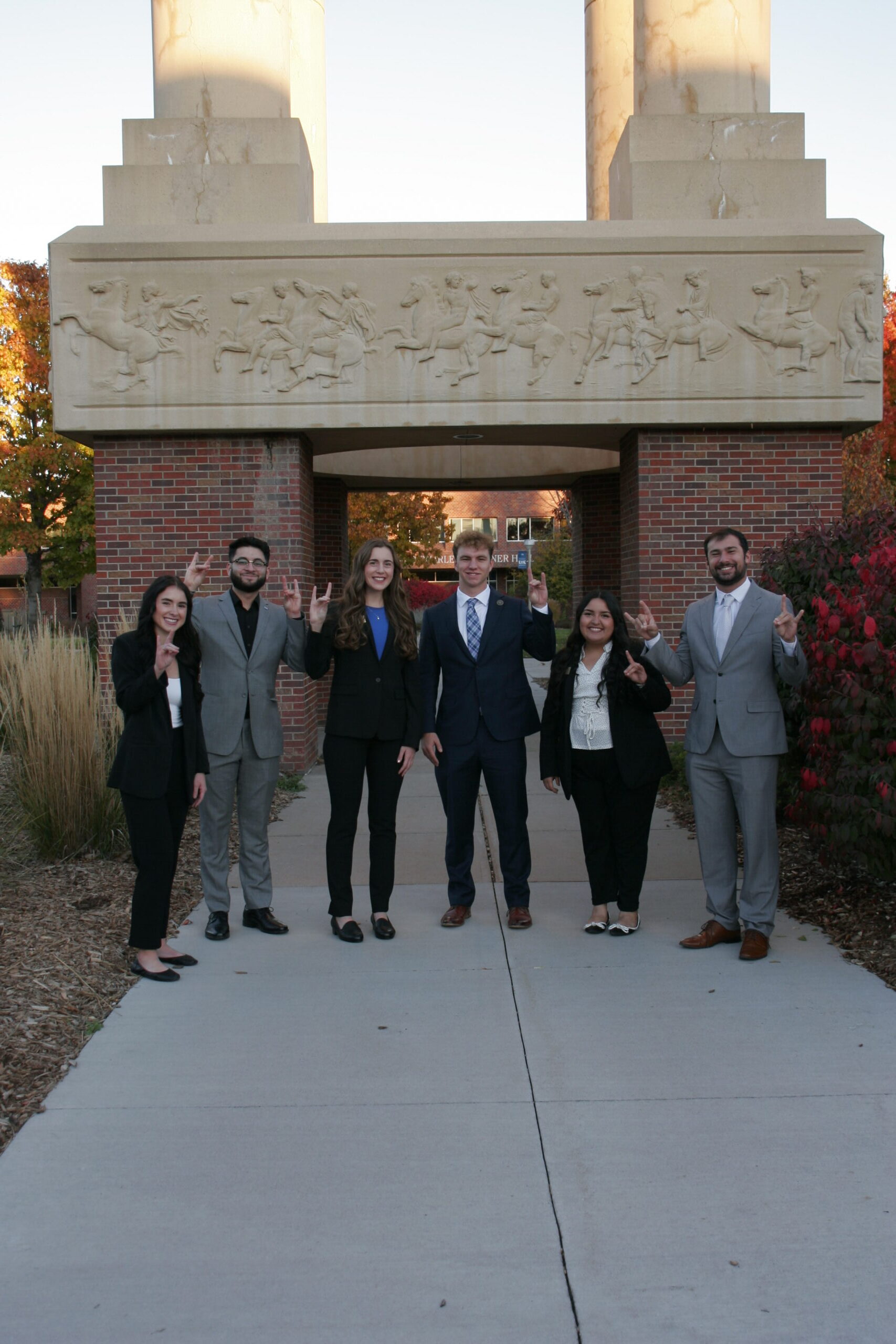 _MG_9420 UNK Student Government Executive branch poses outside of the bell tower.