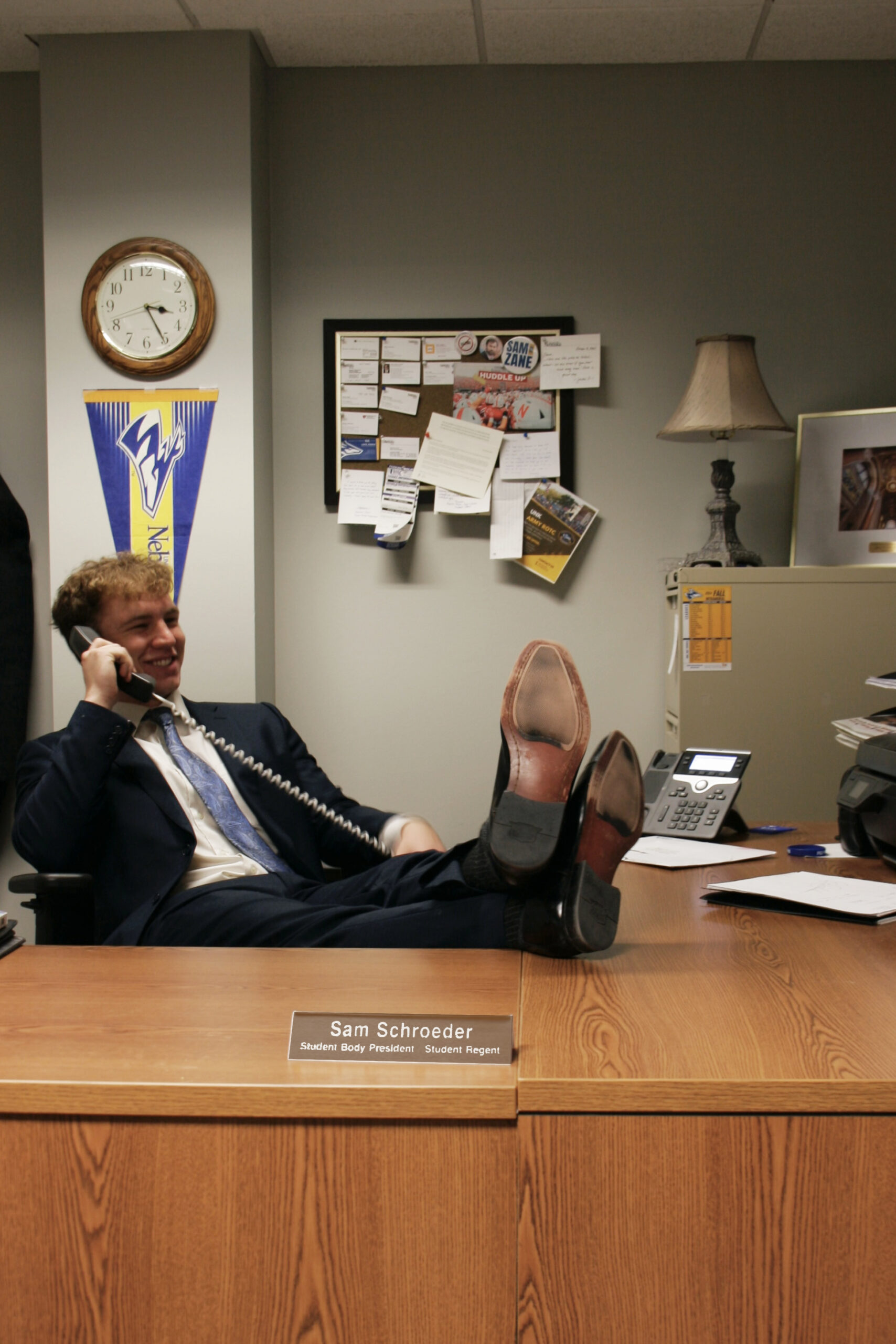 _MG_9554copy UNK President poses in his office with his feet on the desk while talking on the phone.