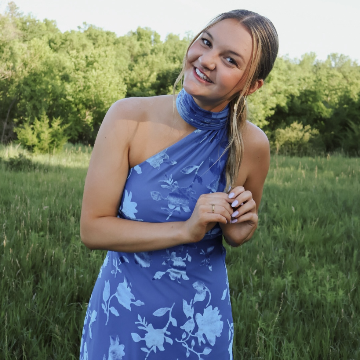 IMG_0415 Travi Tighe in a blue dress in a field.