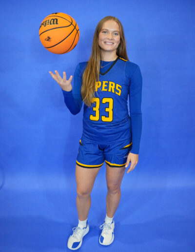 Malgorzata Byczkowska tosses a basketball for a media day photo.