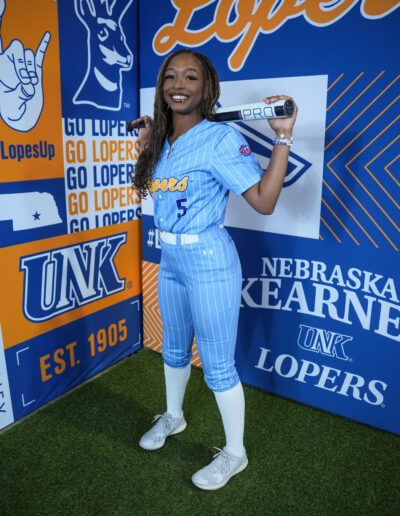 Softball player Zaria Brigham poses for a media day photo with her baseball bat.