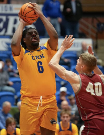 Taylor Harrell shoots the basketball over his Hastings opponent.